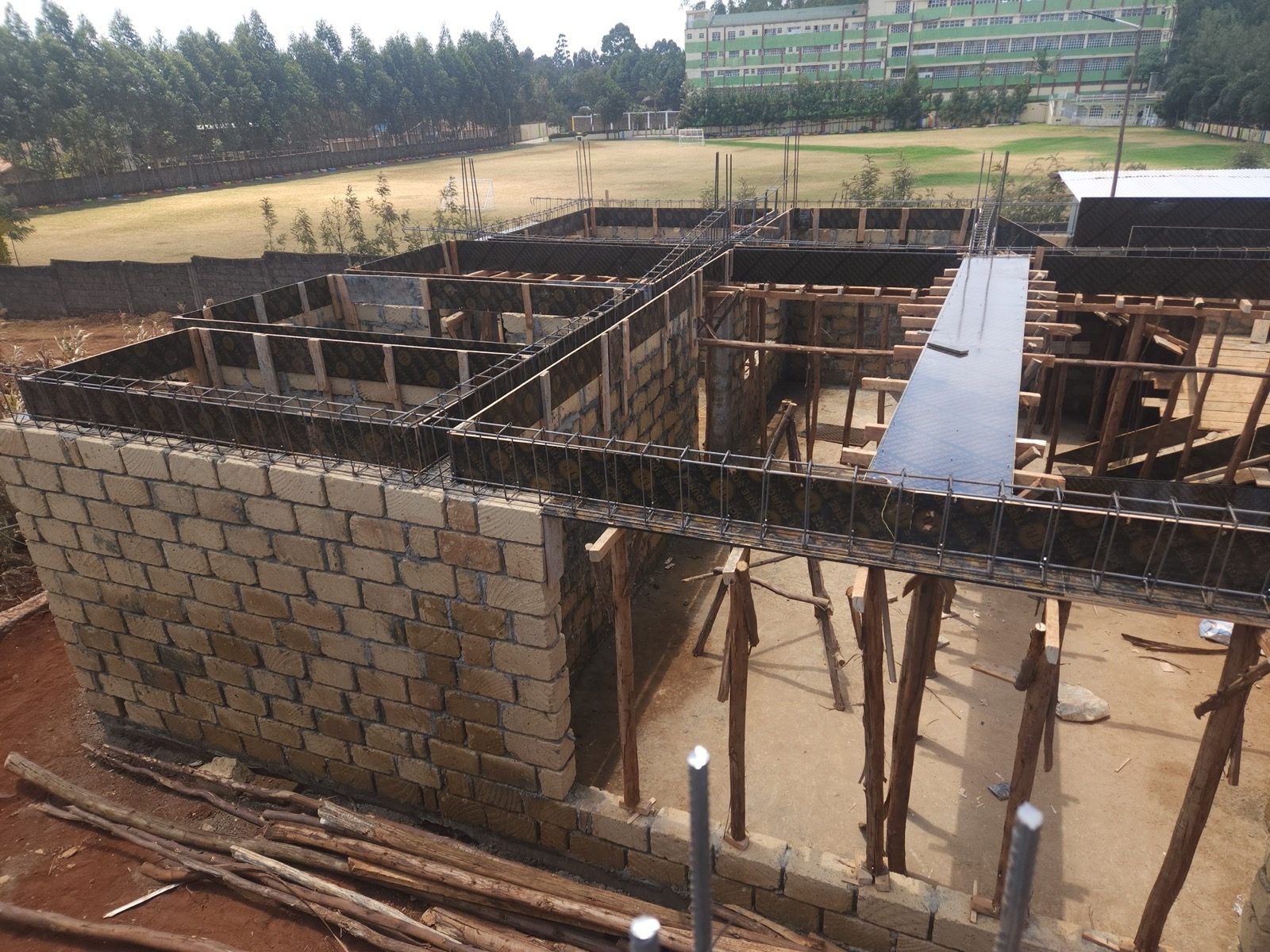 Ground floor machine-cut stone masonry and ring beam formwork at Gikambura Town Houses