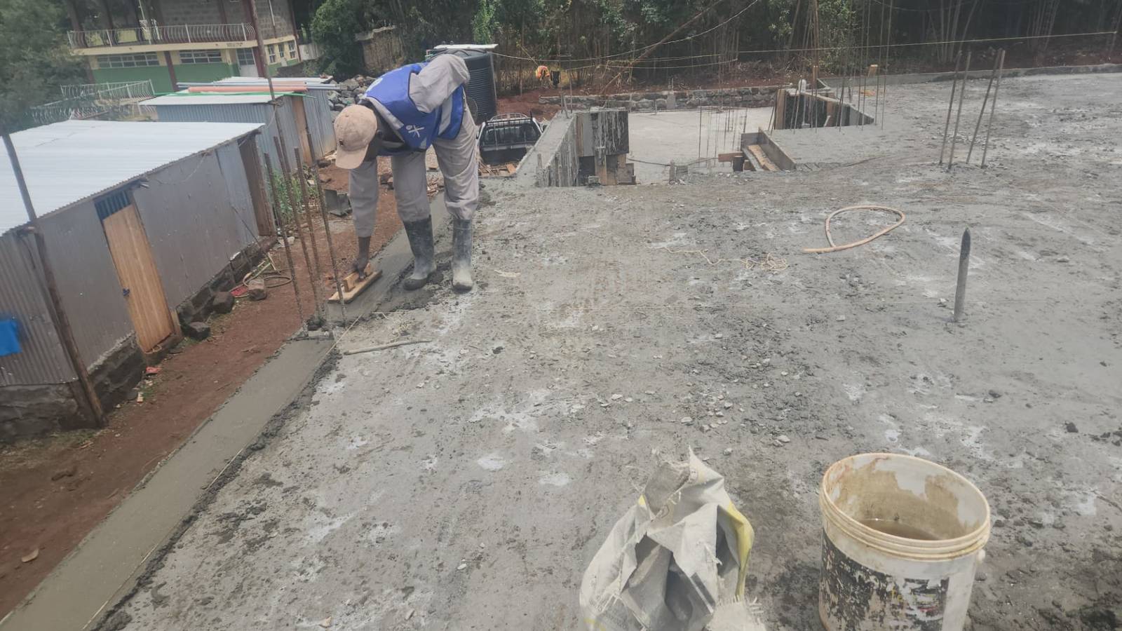 Worker finishing the edge of a concrete slab