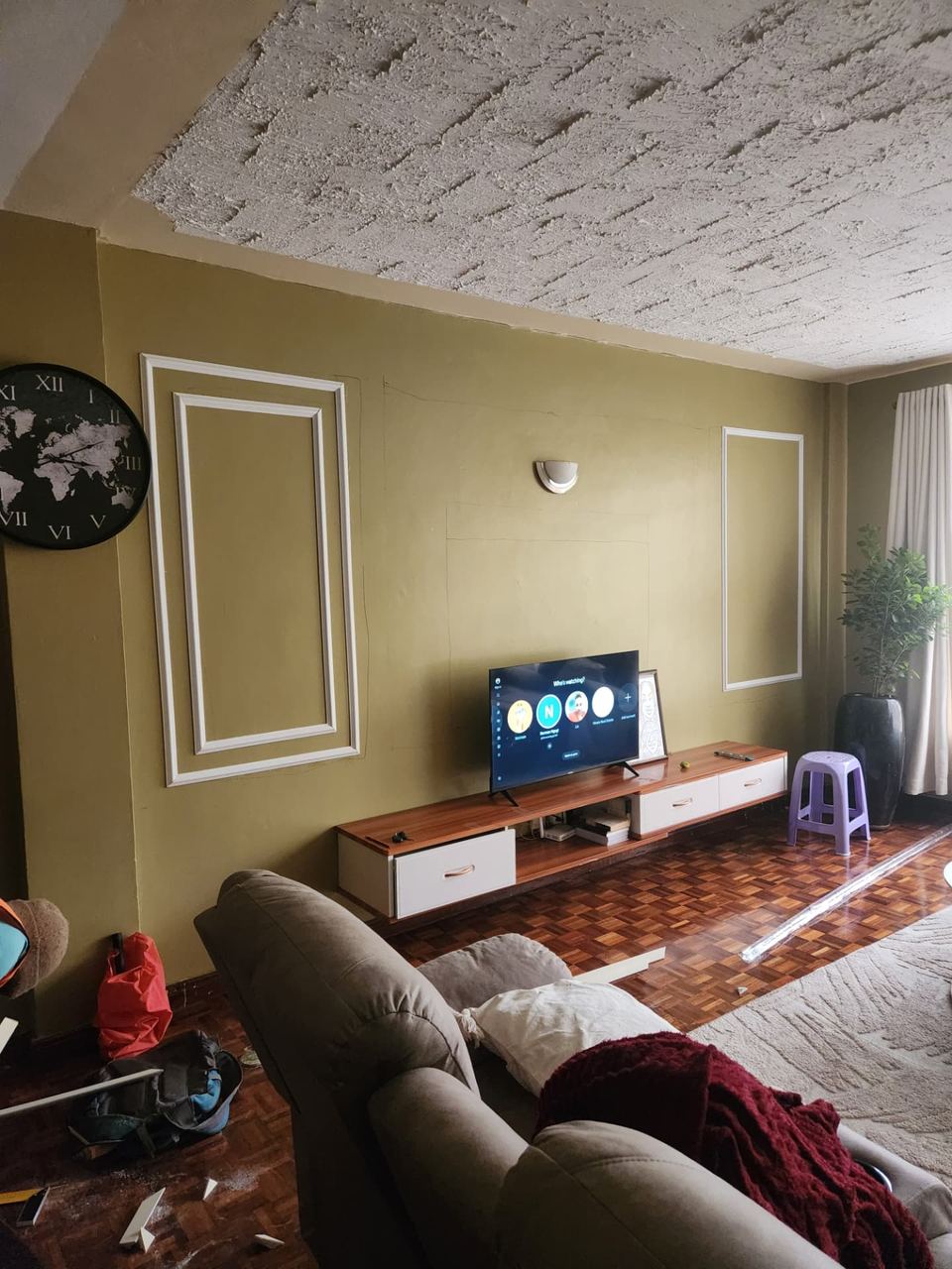 Lounge feature wall before custom wainscoting installation at a private residence in Kiambu