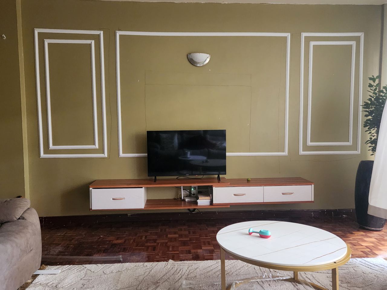 Wainscoting panels fitted around a TV wall at a private residence in Kiambu